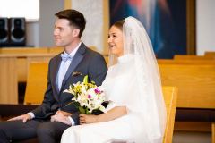 Bride and Groom Smiling During Homily