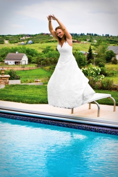 Bride on Pool Diving Board on her Wedding Day