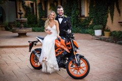 Bride Sitting on Bike with Groom